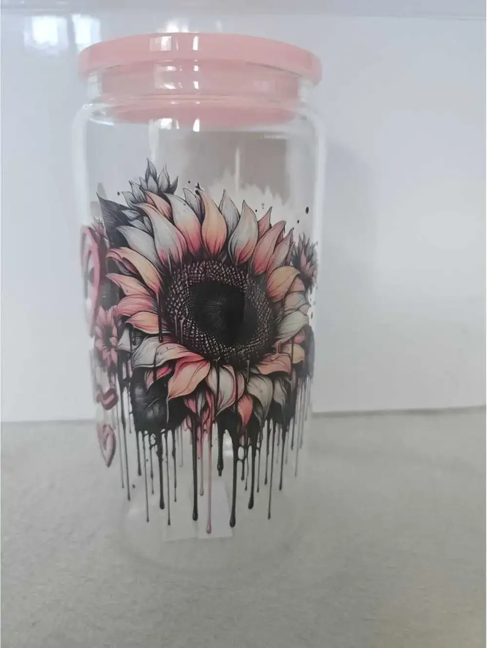 16 oz glass cup with acrylic Lid. Comes w/ straw and straw cleaner.